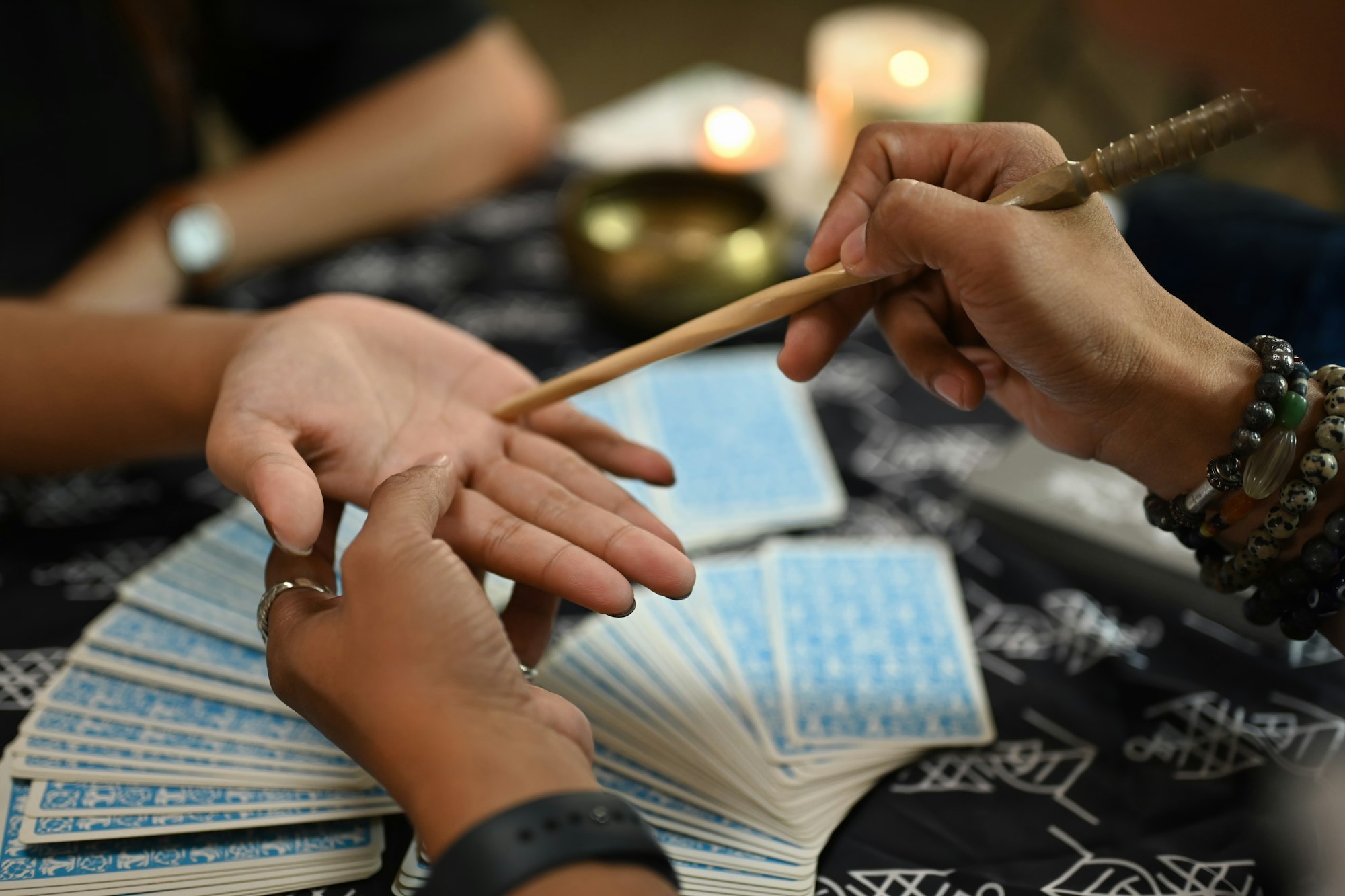 Close up fortune teller reading palm forecasting future of client in dark room. Divination concept